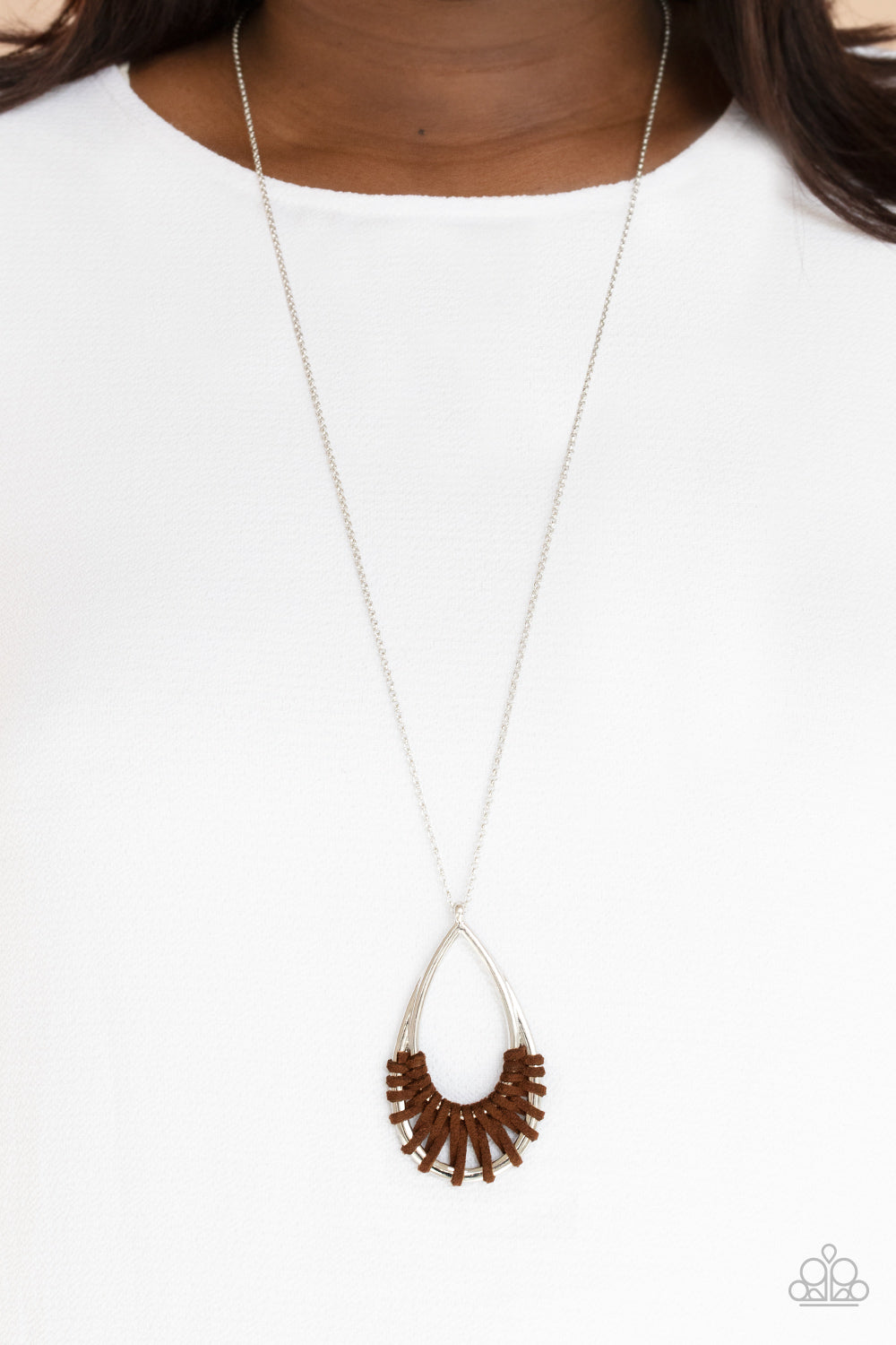 Homespun Artifact Brown Necklace - Paparazzi Accessories  Brown suede cording loops and weaves around the bottoms of a double stacked silver teardrop frame, creating an earthy pendant at the bottom of a dainty lengthened silver chain. Features an adjustable clasp closure.  Sold as one individual necklace. Includes one pair of matching earrings.