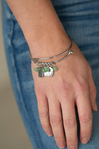 GROWING Strong Green Bracelet - Paparazzi Accessories  Glassy green stone beads and silver floral charms stamped in the words, "faith," "hope," and "peace," glide along a dainty bangle-like cuff around the wrist for a whimsical flair. Features an adjustable toggle closure.  Sold as one individual bracelet.