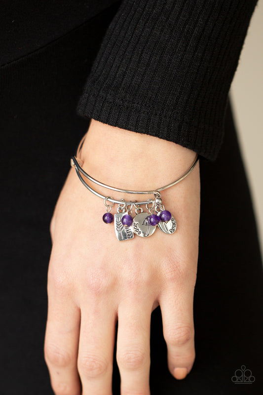 GROWING Strong Purple Bangle Bracelet - Paparazzi Accessories  Glassy purple stone beads and silver floral charms stamped in the words, "faith," "hope," and "peace," glide along a dainty bangle-like cuff around the wrist for a whimsical flair. Features an adjustable toggle closure.  Sold as one individual bracelet.