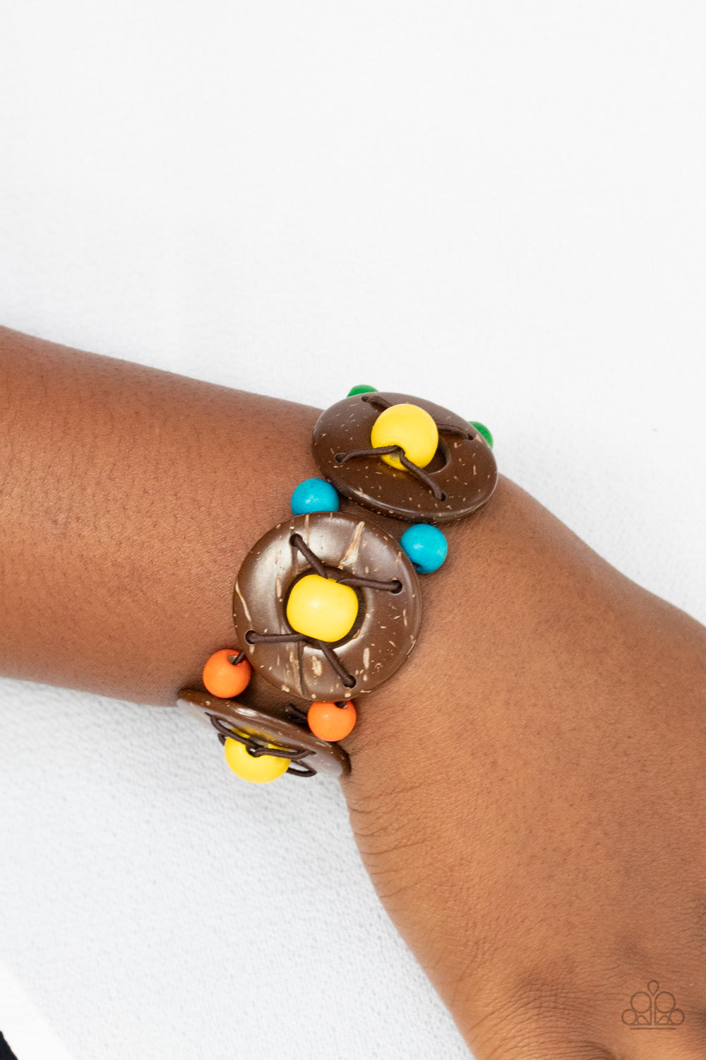 Island Adventure Multi Bracelet - Paparazzi Accessories  An oversized collection of multicolored beads and distressed brown wooden discs are threaded along stretchy bands that decoratively weave around the wrist for a summery flair.  Sold as one individual bracelet.