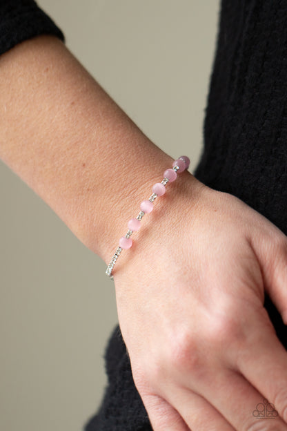 Tea Party Twinkle Pink Bracelet - Paparazzi Accessories  Glassy pink cat's eye stones are fitted in place along a dainty strand of glassy white rhinestones, creating a twinkly cuff around the wrist.  All Paparazzi Accessories are lead free and nickel free!  Sold as one individual bracelet.