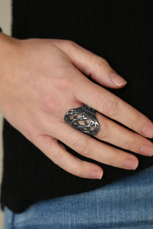Open Fire Black Ring - Paparazzi Accessories  Dainty gunmetal bars delicately crisscross across the finger, weaving into a fiery frame centerpiece. Features a stretchy band for a flexible fit.  All Paparazzi Accessories are lead free and nickel free!  Sold as one individual ring.