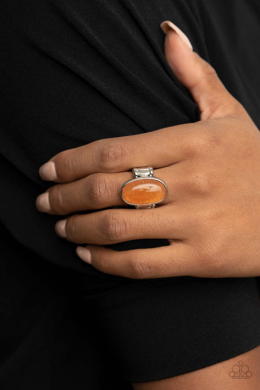 Mystical Mantra Orange Ring - Paparazzi Accessories  An oval orange stone is encased inside a sleek silver frame, creating a mystical centerpiece atop the finger. Features a stretchy band for a flexible fit. As the stone elements in this piece are natural, some color variation is normal.  Sold as one individual ring.