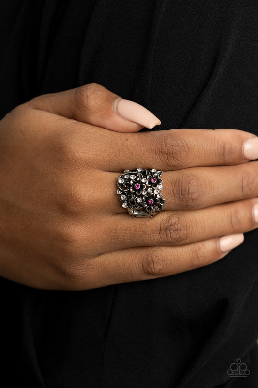 Perfectly Perennial Pink Ring - Paparazzi Accessories  Dotted with dainty pink rhinestone centers, antiqued silver floral frames bloom atop a leafy backdrop of glassy white rhinestones. Features a stretchy band for a flexible fit.  All Paparazzi Accessories are lead free and nickel free!  Sold as one individual ring.