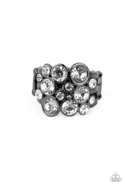 Bubbling Bravado Black Ring - Paparazzi Accessories.  Encased in sleek gunmetal frames, a bubbly collection of sparkly white rhinestones coalesces into a glamorous band across the finger. Features a stretchy band for a flexible fit.  ﻿﻿﻿All Paparazzi Accessories are lead free and nickel free!  Sold as one individual ring.