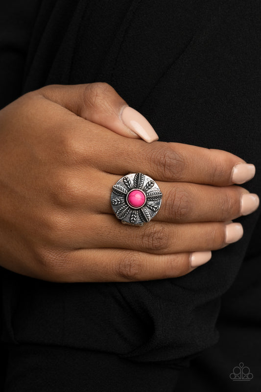 PALMS Reader - Pink Item #P4SE-PKXX-088XX An alternating collection of silver feathers and palm leaves fan out from a vivacious pink stone center atop a silver disc, creating a colorful display atop the finger. Features a stretchy band for a flexible fit.  Sold as one individual ring.
