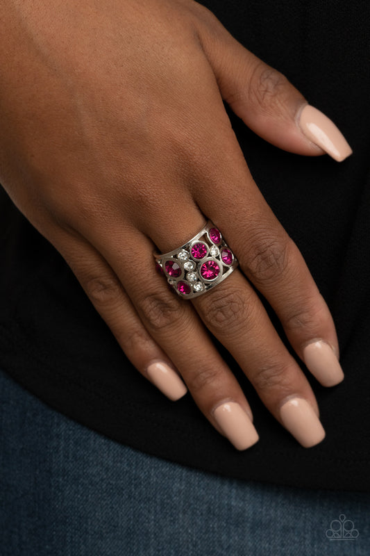 High Roller Royale Pink Ring - Paparazzi Accessories  Sporadic sections of dainty white rhinestones and oversized pink rhinestones haphazardly coalesce inside an airy silver frame, creating a dramatically dazzling centerpiece around the finger. Features a stretchy band for a flexible fit.  All Paparazzi Accessories are lead free and nickel free!  Sold as one individual ring.