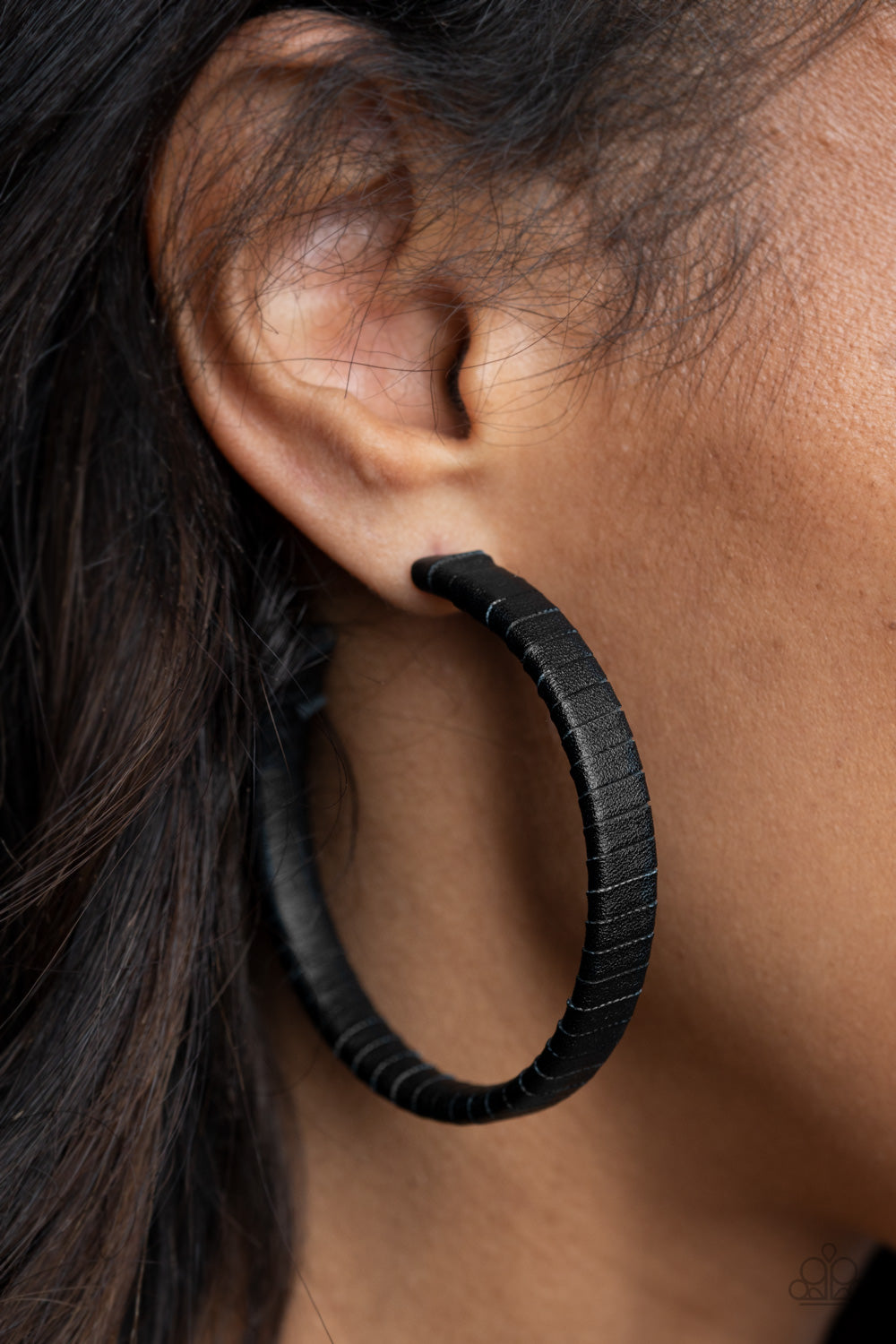 Leather-Clad Legend Black Hoop Earring - Paparazzi Accessories  A black leather lace wraps around a thick silver hoop, creating an edgy display. Earring attaches to a standard post fitting. Hoop measures approximately 2 1/2" in diameter.  All Paparazzi Accessories are lead free and nickel free!  Sold as one pair of hoop earrings.