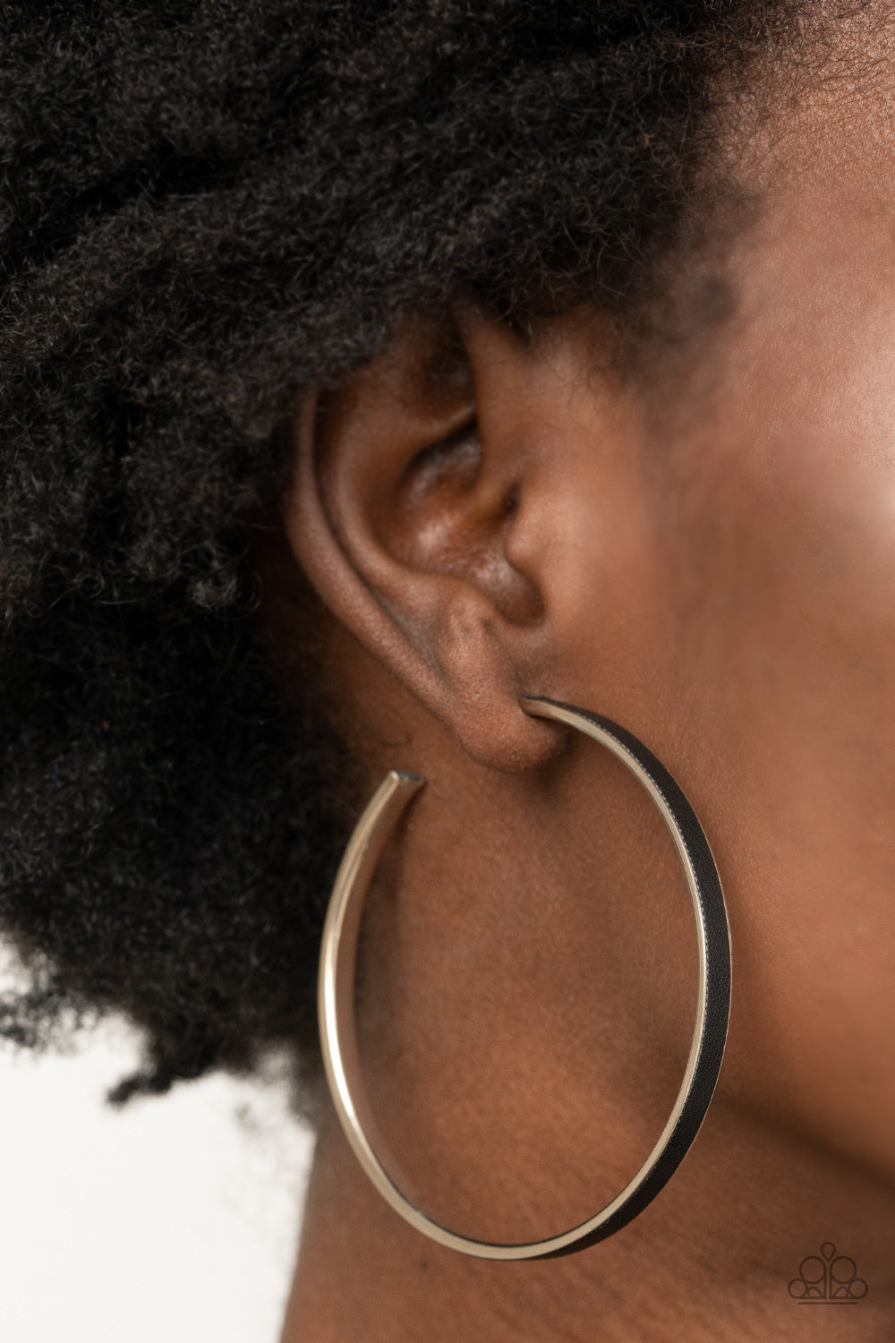 Fearless Flavor Black Hoop Earring - Paparazzi Accessories  A black leather lace is pressed along the indented spine of a silver hoop, creating a bold pop of color. Earring attaches to a standard post fitting. Hoop measures approximately 2 1/4" in diameter.  All Paparazzi Accessories are lead free and nickel free!  Sold as one pair of hoop earrings.