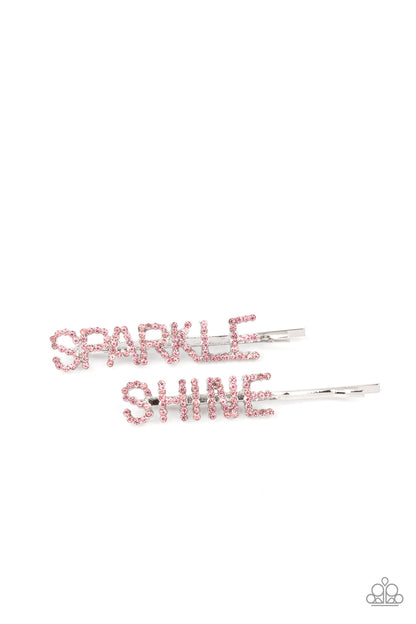 Center of the SPARKLE-verse Pink Hair Clip - Paparazzi Accessories  Glassy pink rhinestones spell out "Sparkle," and "Shine," across the fronts of two silver bobby pins, creating a sparkly duo.  Sold as one pair of decorative bobby pins.