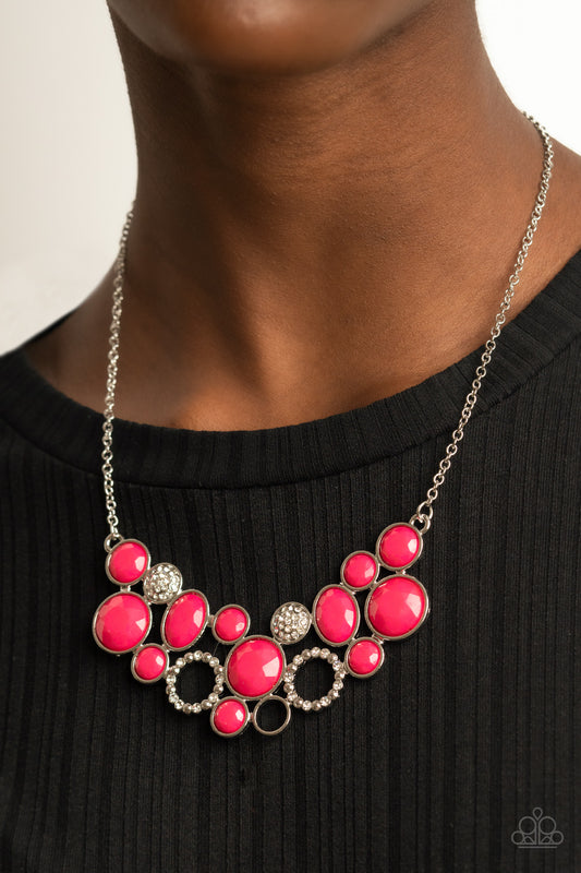 Extra Eloquent Pink Necklace - Paparazzi Accessories  A mismatched collection of faceted pink beaded frames and white rhinestone embellished accents delicately connect into a bubbly clustered pendant below the collar, creating a colorful statement piece. Features an adjustable clasp closure.  All Paparazzi Accessories are lead free and nickel free!  Sold as one individual necklace. Includes one pair of matching earrings.
