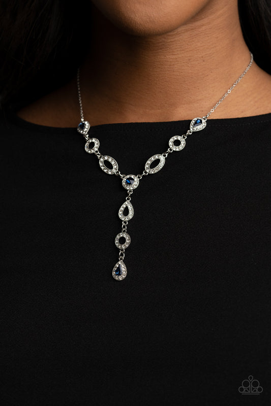 Royal Redux Blue Necklace - Paparazzi Accessories  White rhinestone encrusted oval and teardrop silver frames delicately link with matching blue rhinestone dotted frames below the collar. Matching frames trickle from the center, creating an elegant extended pendant. Features an adjustable clasp closure.  All Paparazzi Accessories are lead free and nickel free!  Sold as one individual necklace. Includes one pair of matching earrings.