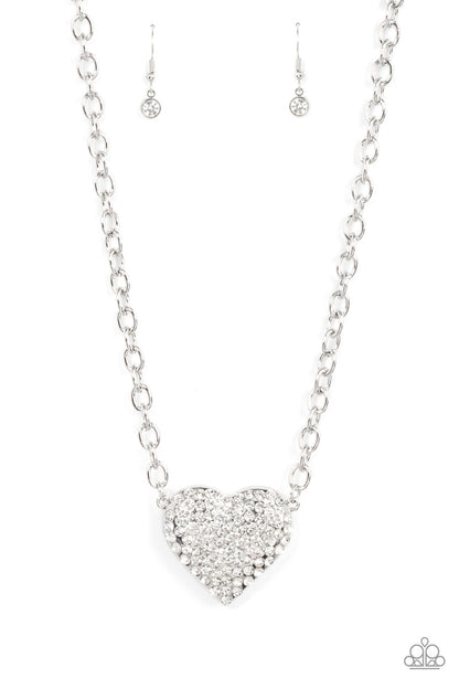 Heartbreakingly Blingy White Necklace - Paparazzi Accessories  A dramatically oversized silver heart frame is encrusted in row after row of dazzling white rhinestones, resulting in heart-racing sparkle below the collar. Features an adjustable clasp closure.  Sold as one individual necklace. Includes one pair of matching earrings.  #P2RE-WTXX-585XX
