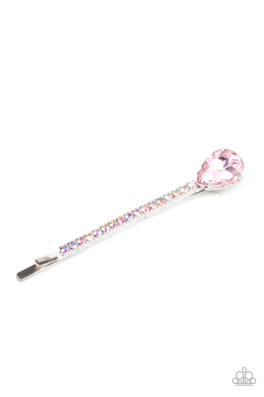 Princess Precision Pink Hair Clip - Paparazzi Accessories.  A pink teardrop gem adorns the corner of a bobby pin that is adorned in opalescent rhinestones for a glamorous finish.  ﻿﻿﻿All Paparazzi Accessories are lead free and nickel free!  Sold as one individual decorative bobby pin.