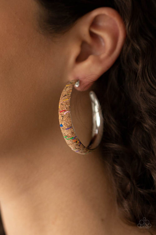 A CORK In The Road Multi Hoop Earring - Paparazzi Accessories  A cork lined silver hoop is splattered in multicolored paint, creating a colorful display. Hoop measures approximately 2" in diameter. Earring attaches to a standard post fitting.  Sold as one pair of hoop earrings.