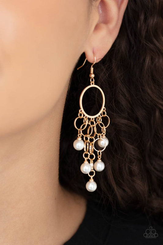 When Life Gives You Pearls Gold Earring - Paparazzi Accessories  Classic white pearls attach to the bottom of strands of dainty gold links, creating a bubbly tassel at the bottom of a timeless gold hoop. Earring attaches to a standard fishhook fitting.  Sold as one pair of earrings.