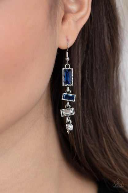 Modern Day Artifact Blue Earring - Paparazzi Accessories  Featuring hammered silver frames, emerald cut dark blue, blue, and white rhinestones stack into an edgy lure. Dotted in glassy white rhinestones, a dainty silver teardrop attaches to the bottom for an abstract finish. Earring attaches to a standard fishhook fitting.  All Paparazzi Accessories are lead free and nickel free!  Sold as one pair of earrings.