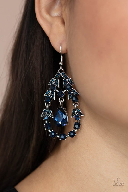 Garden Decorum Blue Earring - Paparazzi Accessories  A solitaire blue teardrop rhinestone swings from the top of an ornately hinged teardrop frame adorned in blue rhinestone dotted leafy silver frames, creating a glamorous centerpiece. Earring attaches to a standard fishhook fitting.  ﻿All Paparazzi Accessories are lead free and nickel free!  Sold as one pair of earrings.