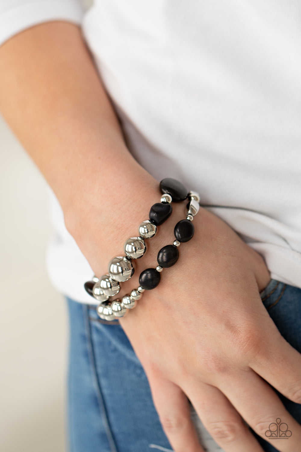 Authentically Artisan Black Bracelet - Paparazzi Accessories. Mismatched black stones and oversized silver beads are threaded along stretchy bands around the wrist, creating earthy layers.  All Paparazzi Accessories are lead free and nickel free!  Sold as one pair of bracelets.