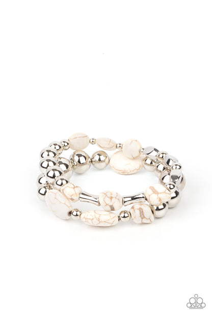 Authentically Artisan White Bracelet - Paparazzi Accessories. Mismatched white stones and oversized silver beads are threaded along stretchy bands around the wrist, creating earthy layers.  All Paparazzi Accessories are lead free and nickel free!  Sold as one pair of bracelets.