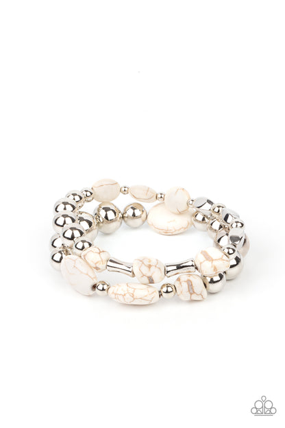 Authentically Artisan White Bracelet - Paparazzi Accessories. Mismatched white stones and oversized silver beads are threaded along stretchy bands around the wrist, creating earthy layers.  All Paparazzi Accessories are lead free and nickel free!  Sold as one pair of bracelets.
