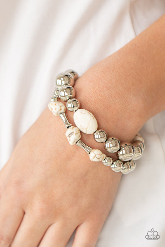 Authentically Artisan White Bracelet - Paparazzi Accessories. Mismatched white stones and oversized silver beads are threaded along stretchy bands around the wrist, creating earthy layers.  All Paparazzi Accessories are lead free and nickel free!  Sold as one pair of bracelets.