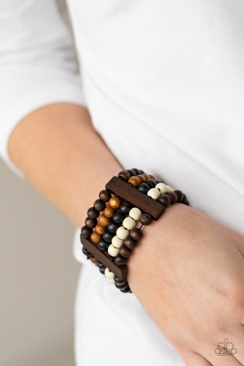 Caribbean Catwalk Multi Wooden Bracelet - Paparazzi Accessories  Held in place by rectangular wooden frames, strands of brown, black, and white wooden beads are threaded along stretchy bands around the wrist for a colorfully tropical look.  All Paparazzi Accessories are lead free and nickel free!  Sold as one individual bracelet.