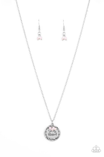 Simple Blessings Pink Necklace - Paparazzi Accessories  Bordered in a leafy pattern, a shiny silver disc is stamped with the phrase, "Simply Blessed," joins a dainty cluster of iridescent and opaque pink crystal-like beads at the bottom of a chain, creating an inspirational pendant below the collar. Features an adjustable clasp closure.  All Paparazzi Accessories are lead free and nickel free!   Sold as one individual necklace. Includes one pair of matching earrings.