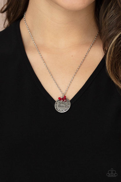 Simple Blessings Red Necklace - Paparazzi Accessories  Bordered in a leafy pattern, a shiny silver disc is stamped with the phrase, "Simply Blessed," joins a dainty cluster of glassy and polished red crystal-like beads at the bottom of a chain, creating an inspirational pendant below the collar. Features an adjustable clasp closure.  All Paparazzi Accessories are lead free and nickel free!   Sold as one individual necklace. Includes one pair of matching earrings.