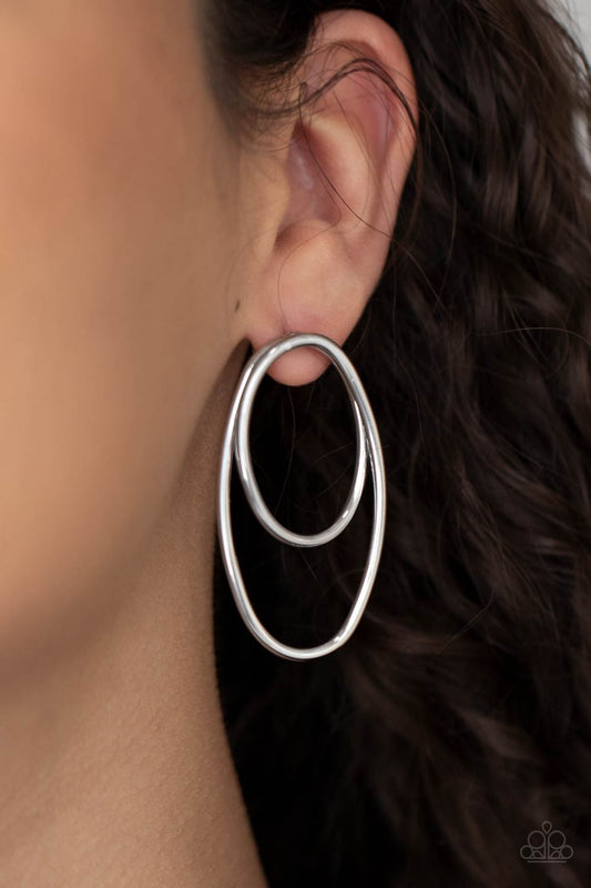 So OVAL-Dramatic Silver Earring - Paparazzi Accessories  Shiny silver wires spin into a stacked oval frame, creating a dizzying look. Earring attaches to a standard post fitting.  All Paparazzi Accessories are lead free and nickel free!  Sold as one pair of post earrings.