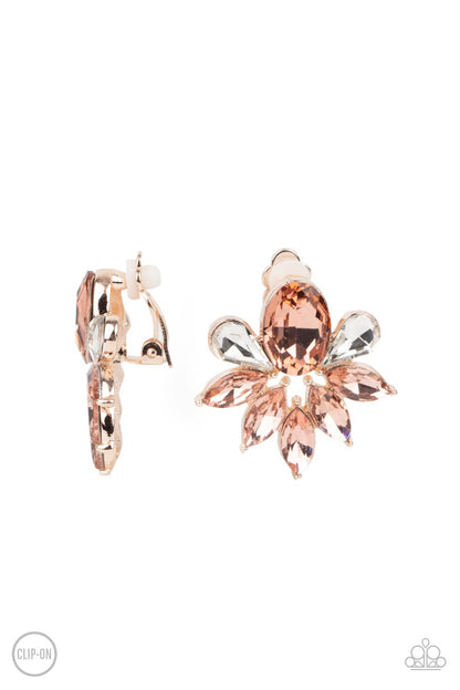 Fearless Finesse Rose Gold Clip-On Earring - Paparazzi Accessories  A glassy collection of white teardrop and rose gold marquise cut rhinestones fan out from the bottom of an oval rose gold gem, creating a majestic centerpiece. Earring attaches to a standard clip-on earring.  ﻿All Paparazzi Accessories are lead free and nickel free!  Sold as one pair of clip-on earrings.