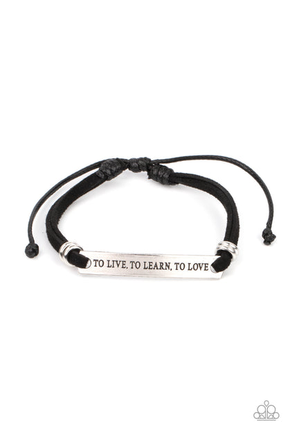To Live, To Learn, To Love Black Bracelet - Paparazzi Accessories  Infused with pairs of silver rings, a silver plate stamped in the phrase, "To Live, To Learn, To Love," is knotted in place around the wrist by black suede bands for an inspirational look. Features an adjustable sliding knot closure.  Sold as one individual bracelet.