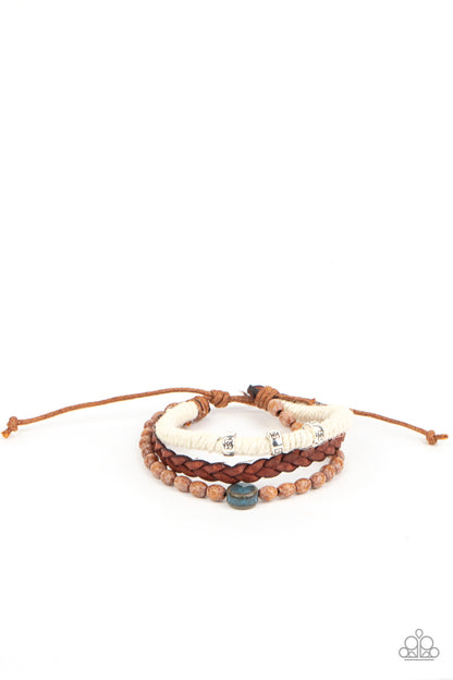 Terrarium Terrain Blue Urban Bracelet - Paparazzi Accessories  Featuring floral stamped accents and a colorful ceramic-like bead, strands of wooden beads, white twine, and braided leather layer around the wrist for an earthy look. Features an adjustable sliding knot closure.  All Paparazzi Accessories are lead free and nickel free!  Sold as one individual bracelet.