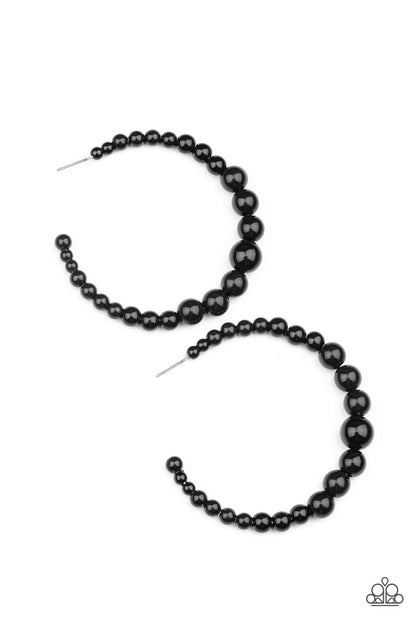 Glamour Graduate Black Hoop Earring - Paparazzi Accessories  Gradually increasing in size at the center, a classic row of polished black beads are threaded along an oversized hoop for a posh finish. Earring attaches to a standard post fitting. Hoop measures approximately 2 1/4" in diameter.  Sold as one pair of hoop earrings.
