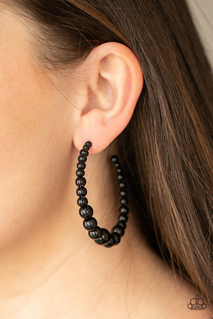 Glamour Graduate Black Hoop Earring - Paparazzi Accessories  Gradually increasing in size at the center, a classic row of polished black beads are threaded along an oversized hoop for a posh finish. Earring attaches to a standard post fitting. Hoop measures approximately 2 1/4" in diameter.  Sold as one pair of hoop earrings.