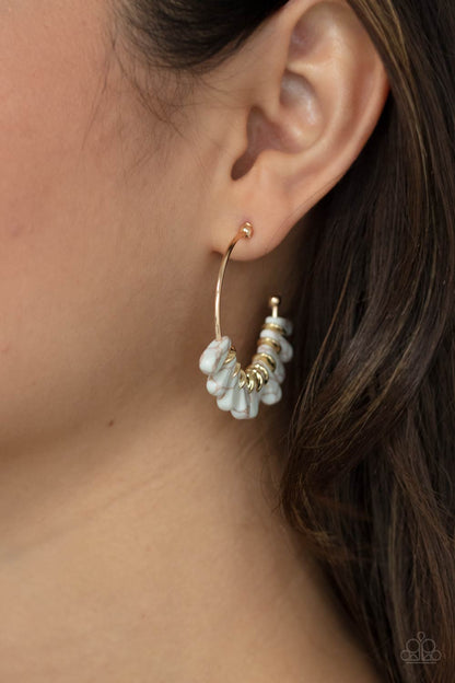 Poshly Primitive White Hoop Earring - Paparazzi Accessories  Flared white stones and dainty gold discs alternate along a dainty gold hoop, creating an earthy fringe. Earring attaches to a standard post fitting. Hoop measures approximately 1 1/2" in diameter.  Sold as one pair of hoop earrings.