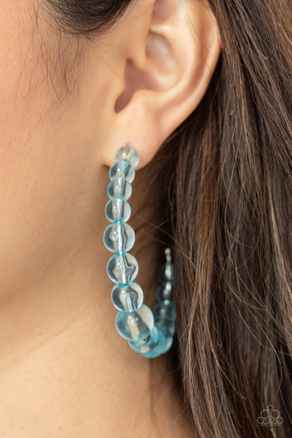 In The Clear Blue Hoop Earring - Paparazzi Accessories  Gradually increasing in size at the center, a glassy collection of Cerulean beads are threaded along an oversized hoop for a bubbly effect. Earring attaches to a standard post fitting. Hoop measures approximately 2 1/2" in diameter.  All Paparazzi Accessories are lead free and nickel free!  Sold as one pair of hoop earrings.