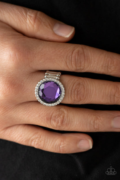 Crown Culture Purple Ring - Paparazzi Accessories.  A round purple gem is bordered in a glassy ring of dainty white rhinestones, creating a sparkly centerpiece atop the finger. Features a stretchy band for a flexible fit.  ﻿All Paparazzi Accessories are lead free and nickel free!  Sold as one individual ring.
