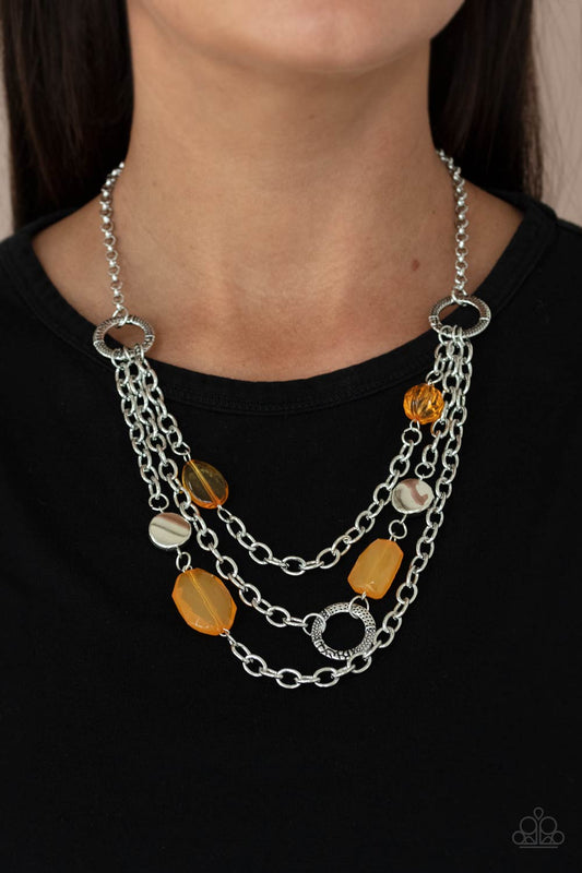 Oceanside Spa - Orange Item #P2ST-OGXX-070XX Varying in shape and opacity, glassy Marigold crystal-like beads, asymmetrical silver discs, and textured silver rings haphazardly adorn three silver chains below the collar for a whimsical pop of color. Features an adjustable clasp closure.  Sold as one individual necklace. Includes one pair of matching earrings.