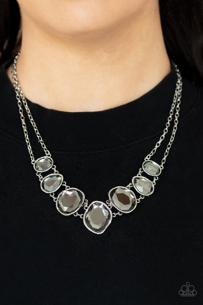 Absolute Admiration Silver Necklace - Paparazzi Accessories  Encased in hammered asymmetrical silver frames, an imperfect collection of faceted smoky gems are suspended from two shimmery silver chains as they double-link below the collar for a dramatic effect. Features an adjustable clasp closure.  Sold as one individual necklace. Includes one pair of matching earrings.