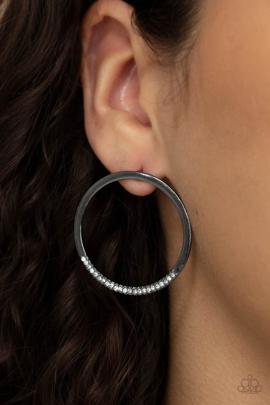 Spot On Opulence Black Post Earring - Paparazzi Accessories  As if dipped in glitter, the bottom of a flat gunmetal hoop is encrusted in dainty white rhinestones for a classic shimmer. Earring attaches to a standard post fitting.  All Paparazzi Accessories are lead free and nickel free!  Sold as one pair of post earrings.