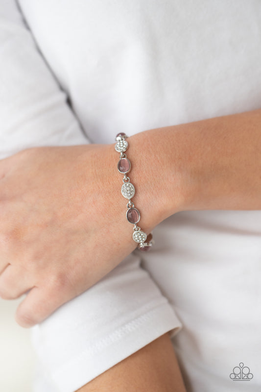 Stop and GLOW Purple Bracelet - Paparazzi Accessories  Dainty white rhinestone encrusted silver frames alternate with purple cat's eye encrusted frames around the wrist, creating a timeless centerpiece. Features an adjustable clasp closure.  Sold as one individual bracelet.