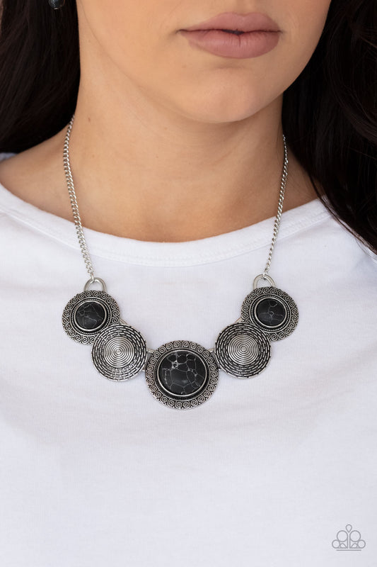 Canyon Cottage Black Necklace - Paparazzi Accessories   Embossed in swirly patterns, black stone frames link with antiqued silver frames radiating with spiral textures below the collar for a seasonal inspired flair. Features an adjustable clasp closure.  All Paparazzi Accessories are lead free and nickel free!  Sold as one individual necklace. Includes one pair of matching earrings.
