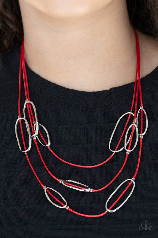 Check Your CORD-inates Red Necklace - Paparazzi Accessories  An asymmetrical collection of hammered silver ovals are fitted in place along three rows of shiny red cords, creating an edgy display below the collar. Features an adjustable clasp closure.  All Paparazzi Accessories are lead free and nickel free!  Sold as one individual necklace. Includes one pair of matching earrings.