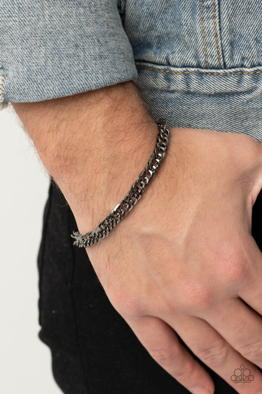 Very Valiant Black Urban Bracelet - Paparazzi Accessories  Featuring diamond-cut textures on one side and a smooth finish on the other, a glistening gunmetal curb chain wraps around the wrist for a reversible versatile look. Features an adjustable clasp closure.  Sold as one individual bracelet.  Get The Complete Look! Necklace: "Valiant Victor - Black" (Sold Separately)