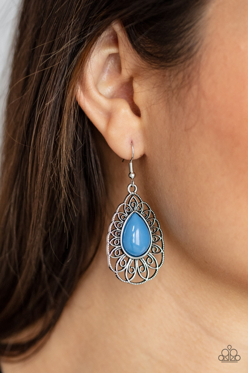 Dream STAYCATION Blue Earring - Paparazzi Accessories.  A shiny French Blue teardrop bead is pressed into the center of an airy silver teardrop frame radiating with ornate petals for a whimsical finesse. Earring attaches to a standard fishhook fitting.  ﻿All Paparazzi Accessories are lead free and nickel free!  Sold as one pair of earrings.
