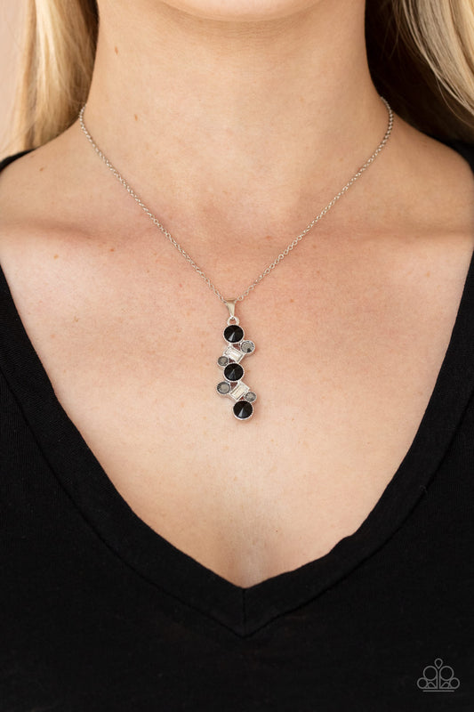 Classically Clustered Black Necklace - Paparazzi Accessories  Featuring classic round and regal emerald style cuts, a glittery collection of black, hematite, and white rhinestones delicately coalesce into a glamorous pendant below the collar. Features an adjustable clasp closure.  All Paparazzi Accessories are lead free and nickel free!   Sold as one individual necklace. Includes one pair of matching earrings.