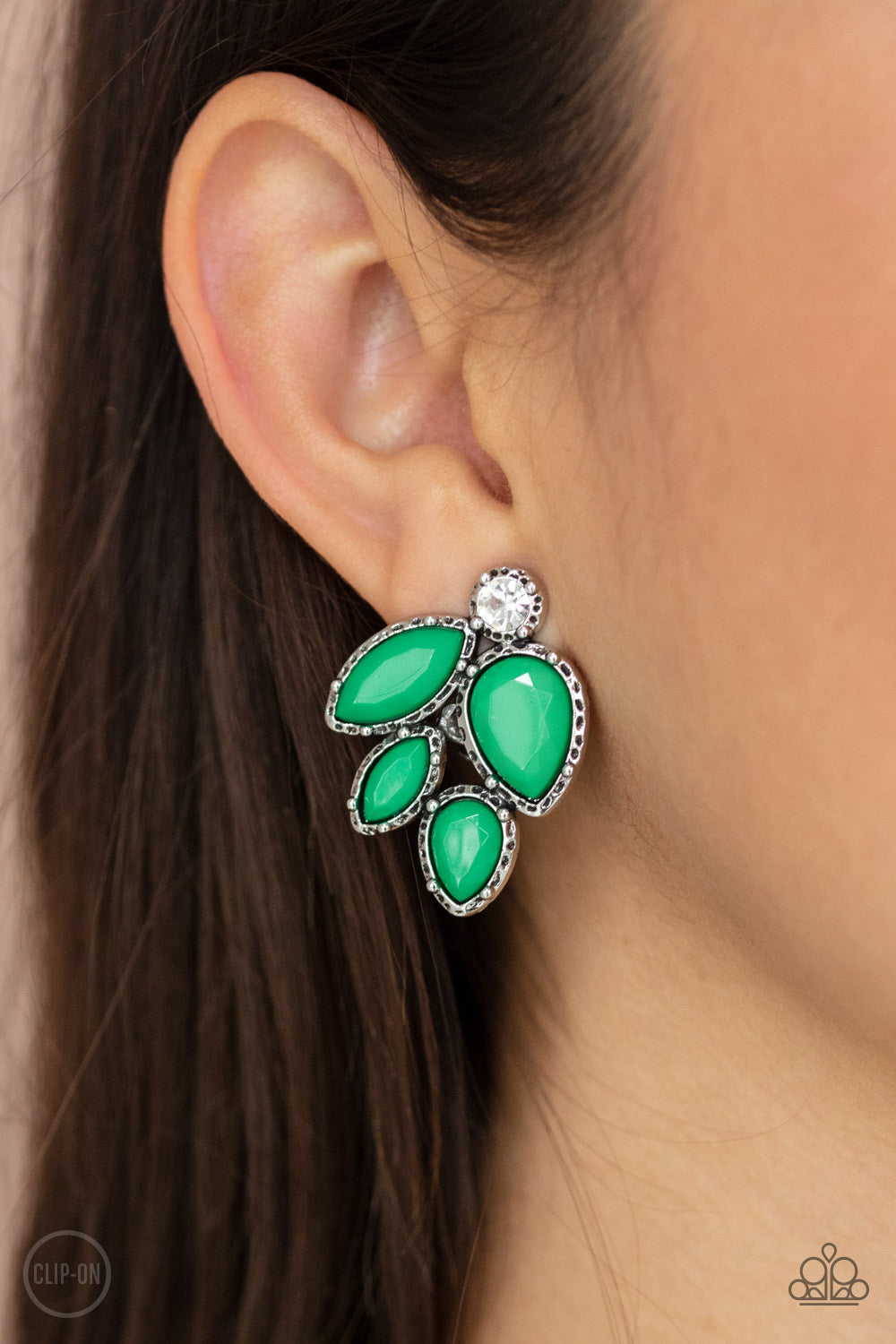 Fancy Foliage Green Clip-On Earring - Paparazzi Accessories  Featuring a dainty white rhinestone, faceted Mint teardrop and marquise beads are pressed into hammered silver fittings that coalesce into a leafy frame. Earring attaches to a standard clip-on fitting.  All Paparazzi Accessories are lead free and nickel free!   Sold as one pair of clip-on earrings.