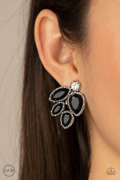 Fancy Foliage Black Clip-On Earring - Paparazzi Accessories.  Featuring a dainty white rhinestone, faceted black teardrop and marquise beads are pressed into hammered silver fittings that coalesce into a leafy frame. Earring attaches to a standard clip-on fitting.  ﻿﻿﻿All Paparazzi Accessories are lead free and nickel free!  Sold as one pair of clip-on earrings.