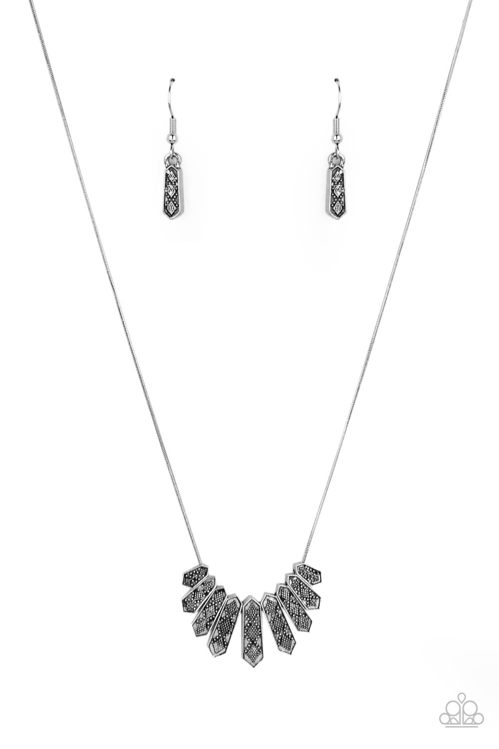 Monumental March Silver Necklace - Paparazzi Accessories  A row of silver obelisk-like monuments gradually decrease in size as they fan out across the collar. Delicately embossed with textured diamond shapes, they march along a dainty round silver chain. Features an adjustable clasp closure.  All Paparazzi Accessories are lead free and nickel free!  Sold as one individual necklace. Includes one pair of matching earrings.
